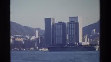 Hong Kong (1984): Waterfront Skyline Of A City In Front Of Mountains A Ship Or