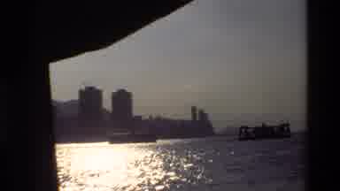 Hong Kong (1984): City Viewed From The Water Followed By A Close Up Of A Clock