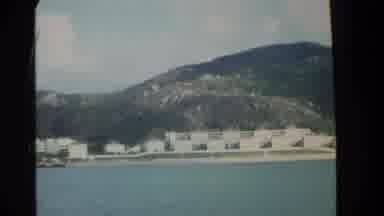 Hong Kong (1984): Person In Boat Viewing The Side Of A Mountainous Island