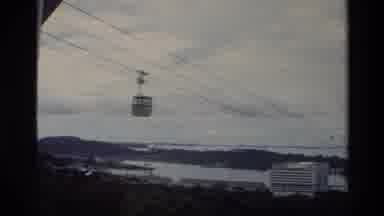 Thailand (1984): Yellow Aerial Tram Moving Along Line Over River And Trees
