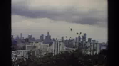 Thailand (1984): View Of Large City Zoomed In To Show Two Cranes On Top Of A Very