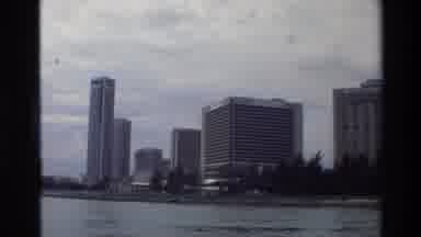 Thailand (1984): On A Boat Looking At Large Office Buildings From A Distance