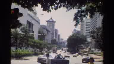 THAILAND-1984: Traffic In A City With Pedestrians And Trees