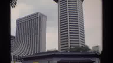Thailand (1984): Two High Story White Buildings Each With Unique Architecture Rise