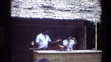 Thailand (1984): Man And Women Employees At Tropical Resort Entertain Guests By