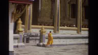 Thailand-1984: Monk In Yellow Robe Walking Past Ornate Temple