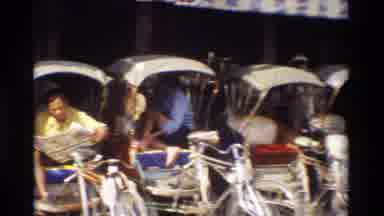 Thailand (1984): A Man Sitting In A Bicycle Rickshaw And Reading A Newspaper