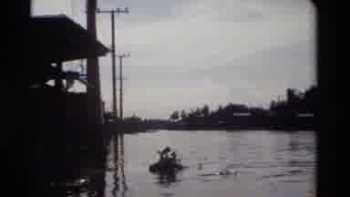 Thailand (1984): Cameraman Moving On A Body Of Water Near Electric Poles