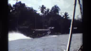 Thailand (1984): People Canoeing And Driving In A Boat On The Water In The Tropics