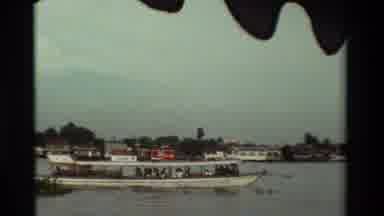 Thailand (1984): Wooden Boat Sails Under Calm Leafy River Carrying Passengers On