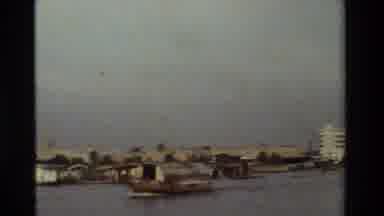 Thailand (1984): A Father And His Child Sit On A Boat Going Along A River
