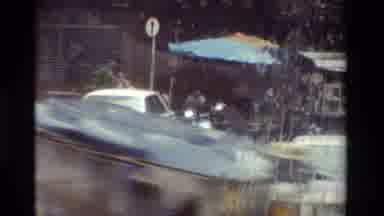 Thailand (1984): It's Raining Outside While A Guy Rides His Motorcycle In The