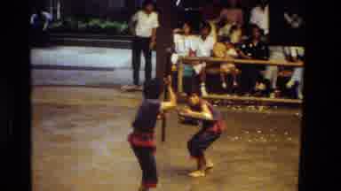 Thailand (1984): People Wearing Bright Colored Clothes Dancing And A Martial Arts