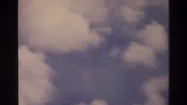 Thailand (1984): View Of Clouds And Ground Below From Aircraft Zooming In On
