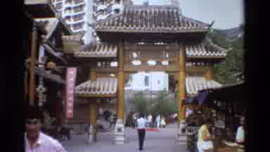 Thailand-1984: Asian Women Stand Near A Contemporary High-Rise Building And A Traditional Temple Gate