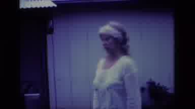 Aliso Viejo California USA (1977): Middle Age Woman In White Acknowledges Camera