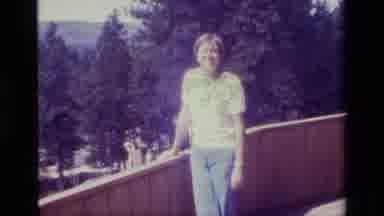 Big Bear California USA (1977): Smiling Woman Standing On A Balcony Overlooking A