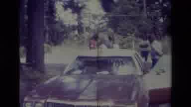Big Bear California USA (1977): People Gathering Behind A Car And A Very Large