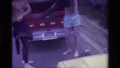 Laguna Beach California USA (1977): Two Man Behind A Truck With A Dog Putting On