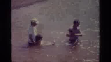 Lake Elsinore California USA (1977): Tree People In The Water With Kid Trying