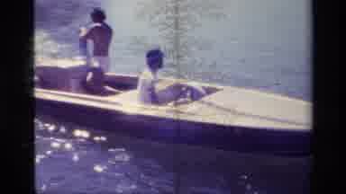 Lake Elsinore California USA (1977): Two People In A Small Boat Drive By A Person