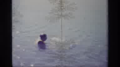 Lake Elsinore California USA (1977): Man Wearing Life Jacket Floating In Water