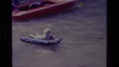 Canyon Lake California USA (1978): Child Playing In The Sea With A Mat Near A