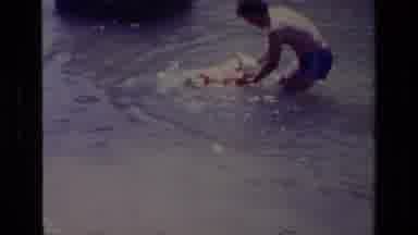 Canyon Lake California USA (1978): Father Teaching Child How To Swim In Lake