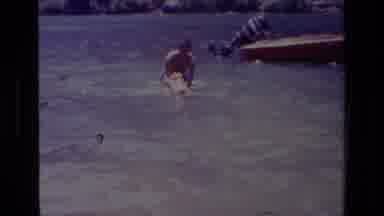 Canyon Lake California USA (1978): Man Helping His Dog Swim In The Lake From Boat