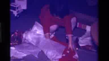 California USA (1979): Child Wearing Red Dress Opening Multiple Gifts On Christmas