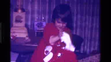 California USA (1979): Child With Red Christmas Outfit With White Trim At