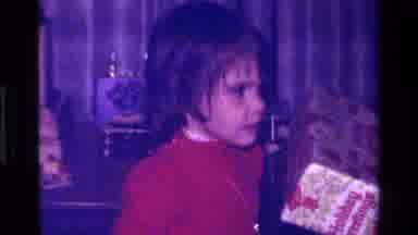 California USA (1979): A Little Girl Dressed In Red Receives A Present From An