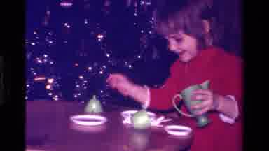 California USA (1979): Young Child Having An Imaginary Tea Party With A Plastic