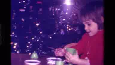California USA (1979): A Child Pretending To Pour Something From A Tea Cup