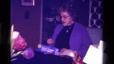 California USA (1979): Woman Questions Box Child Plays Outside Ride Along Toy