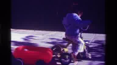 California USA (1979): A Little Girl In A Blue Sweatshirt Riding Her Tricycle