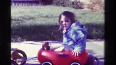 California USA (1979): A Little Girl In A Movable Bike Wagon