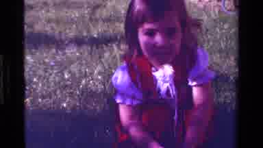 California USA (1979): Little Girl In Red And White Dress Talking And Playing With