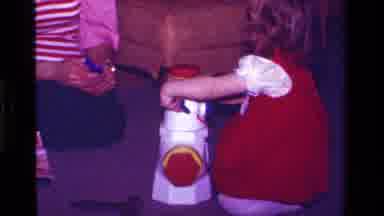 California USA (1979): Little Girl In Red Dress Playing With Her Pop Up Snowman