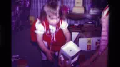 California USA (1979): Little Girl In Red Dress Steals Toy From Other Girl On The