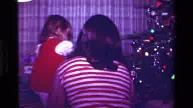 California USA (1979): Little Girl Passes Out Gifts From Under The Christmas Tree