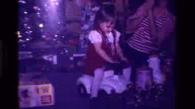 California USA (1979): Little Girl In Red Dress Plays With Her New Car Toy On
