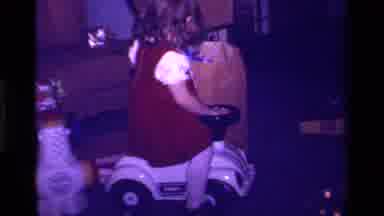 California USA (1979): Little Girl Playing On Car Toy While Opening The Rest Of