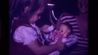 California USA (1979): Little Girl Feeding Her Own Personal Little Baby Doll With
