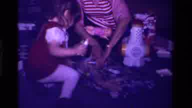 California USA (1979): Mom Opening Wooden Wrapped Present With The Help Of
