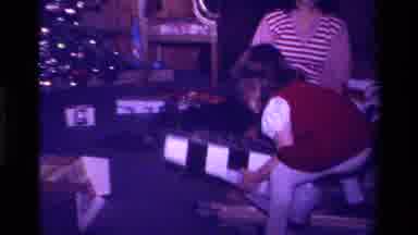 California USA (1979): A Child Opening A Christmas Gift At The Foot Off A