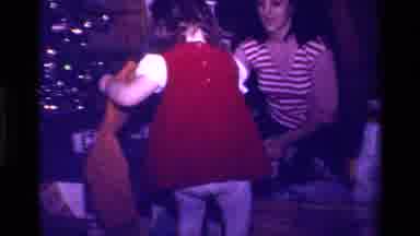 California USA (1979): Child In Red Dress Opens Christmas Presents With Her Mother