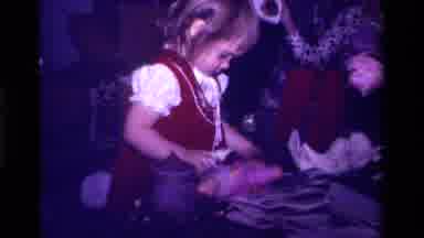 California USA (1979): Small Female Child Practicing Her Mothering Skills On A