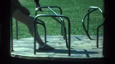 California USA (1979): A Little Girl Playing On Merry Go Round With Mom