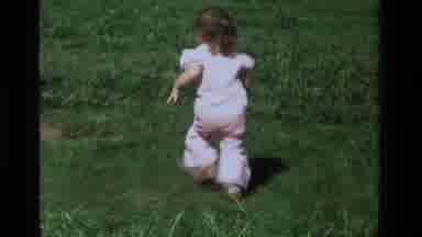 California USA (1979): Little Girl Playing At The Backyard On The Green Grass